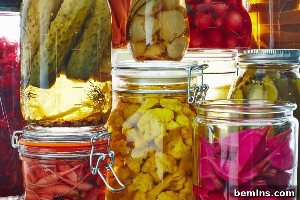 Preserving the Harvest: 10 Winter-Ready Techniques 4 Assortment of pickled vegetables in glass jars, including cucumbers, carrots, and onions.