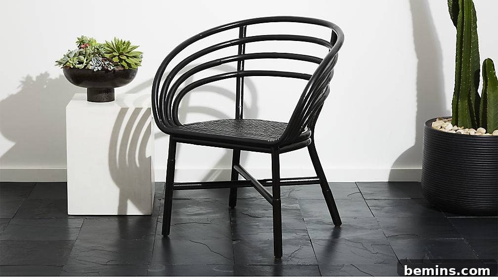 A modern and curvy rattan chair from CB2, a sleek and sophisticated seating option