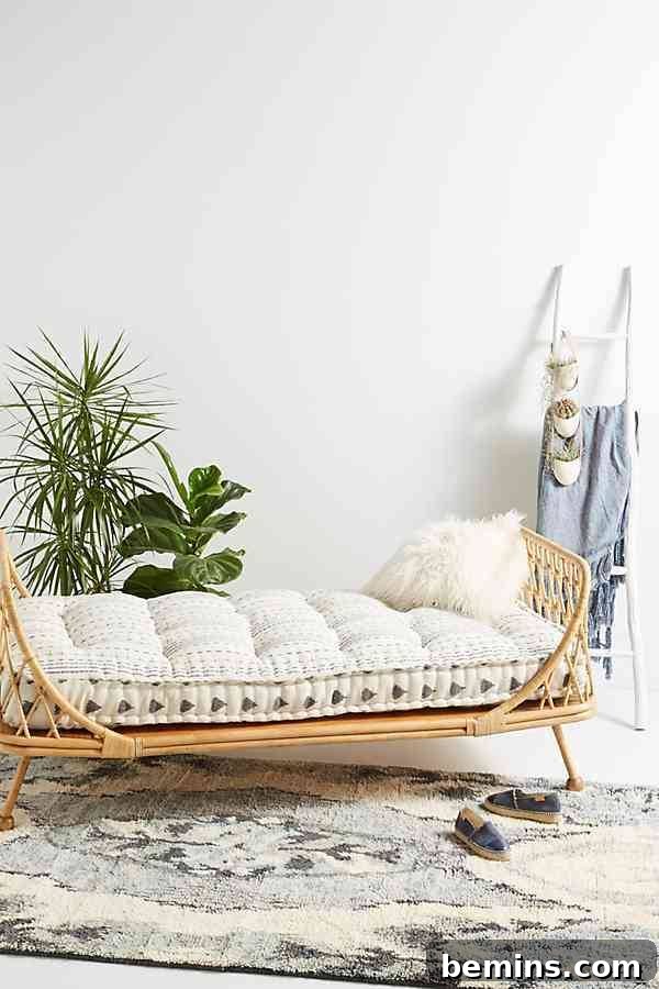 A stylish rattan daybed, perfect for a modern bedroom or living space