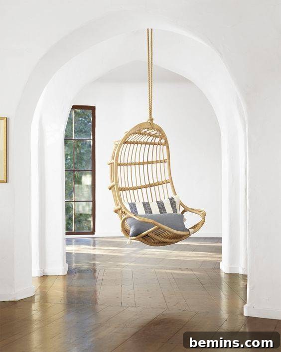 A luxurious rattan hanging chair from Serena & Lily, perfect for creating a cozy retreat