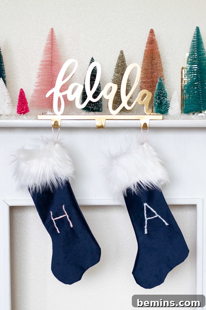 Blue christmas stockings under colored christmas trees on the mantle.