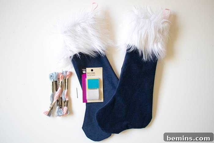 Two dark blue Santa stockings hanging on the wall