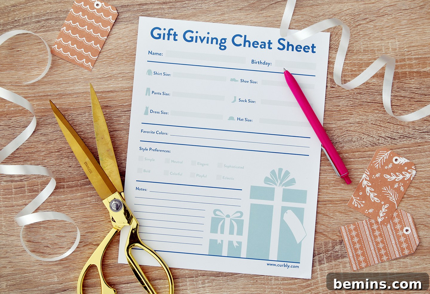 Printable gift giving sheet surrounded by scissors, ribbon, and a pen.