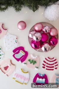 A Vibrant Boho Holiday Pom Pom Wreath 12 Green tree decorations are above pink ornaments and clothing crafts.