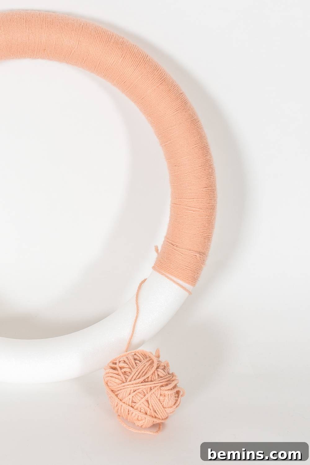 A Vibrant Boho Holiday Pom Pom Wreath 6 Yarn-wrapped wreath