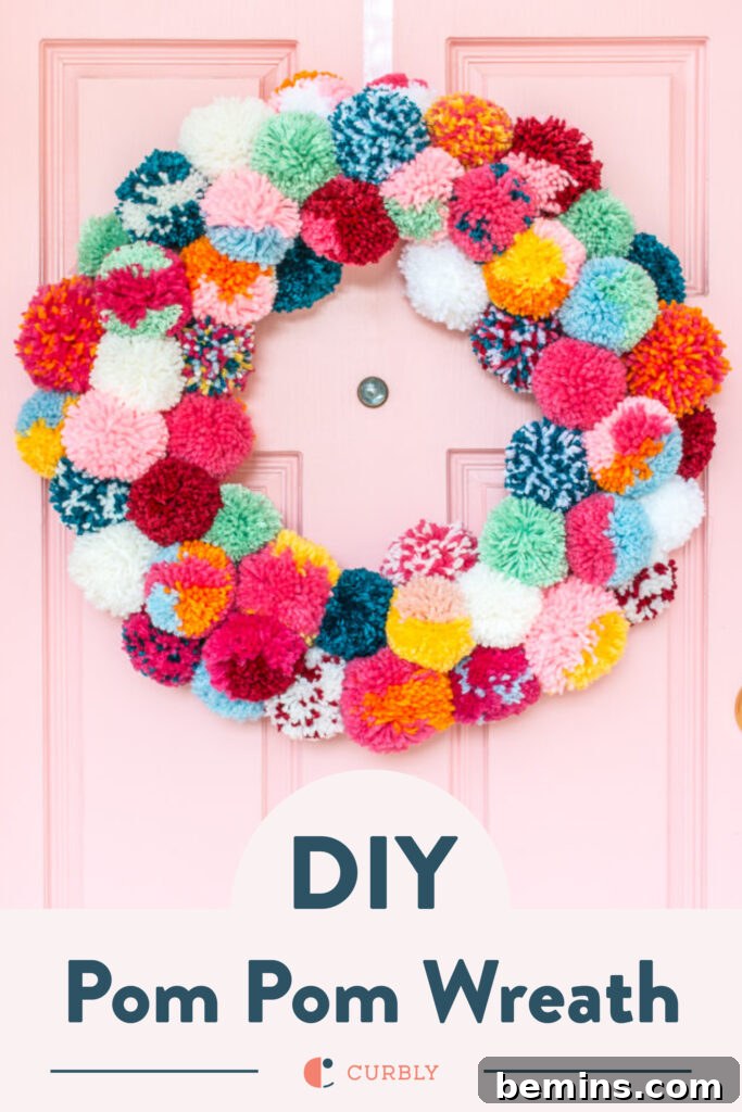 A Vibrant Boho Holiday Pom Pom Wreath 10 colorful pom pom wreath on a pink door