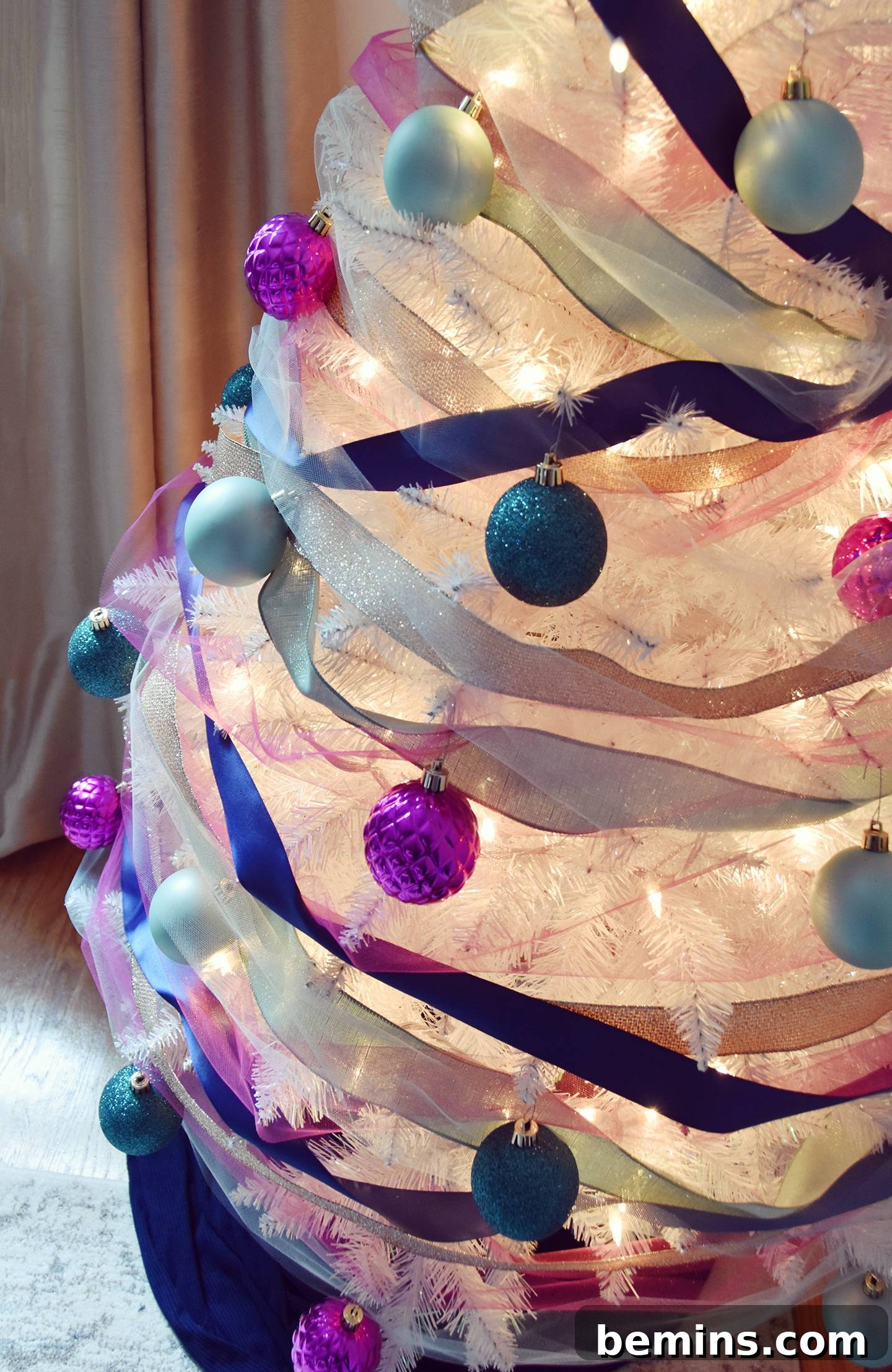 Close-up of a Christmas tree decorated with ribbon and ornaments