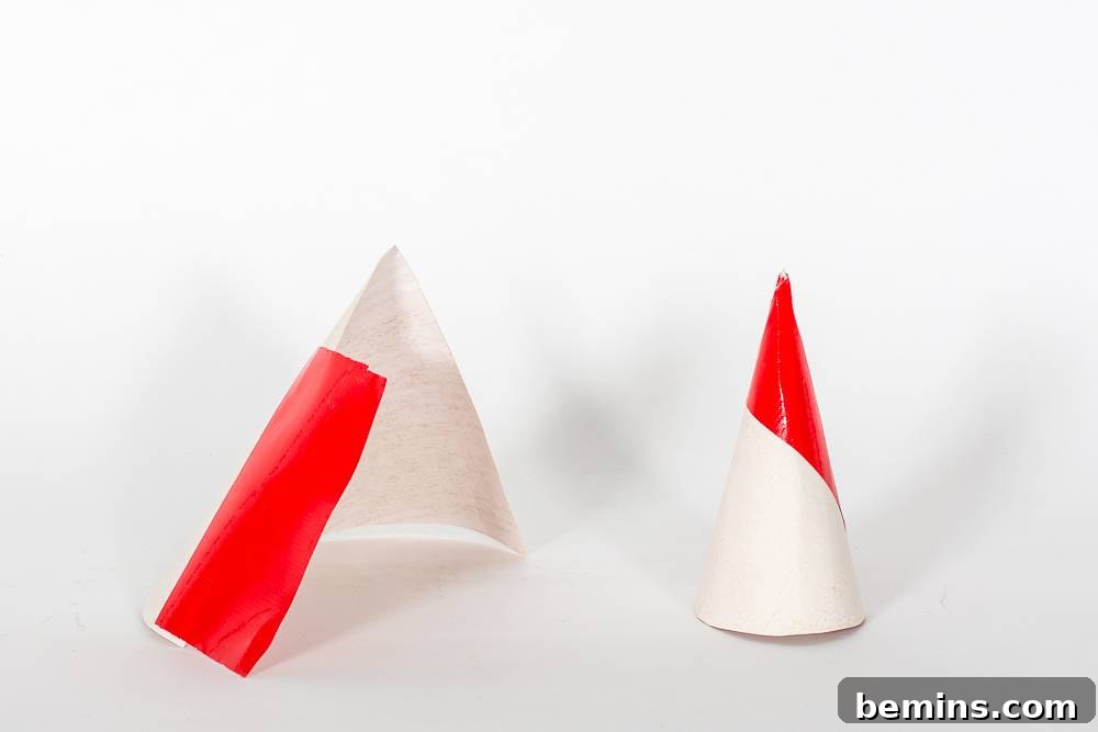Crafting Miniature Concrete Christmas Trees: A DIY Holiday Project 6 White Cone with a Red Tip on it.