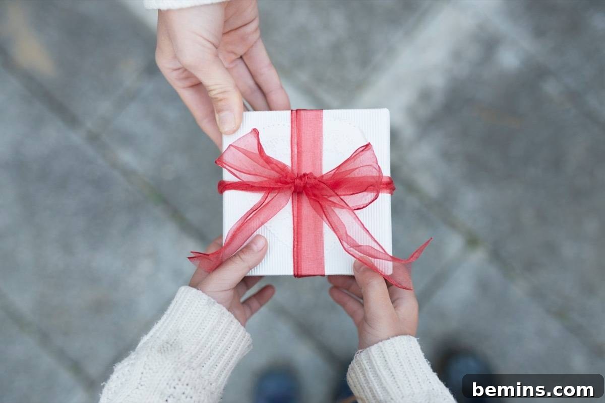 Parent handing over a Christmas gift to a child.