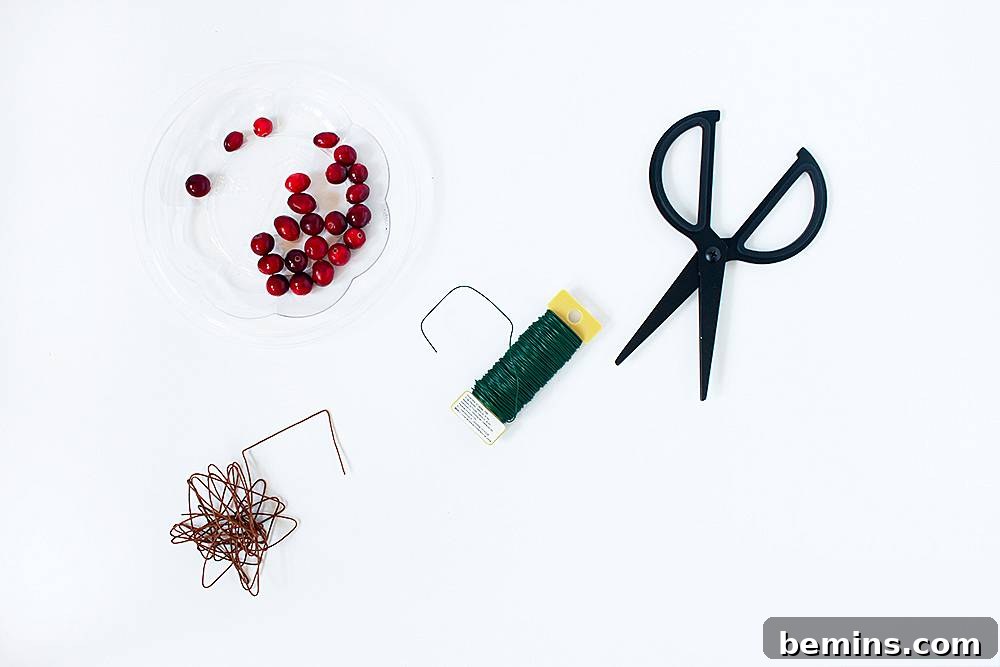 A black pair of scissors is sitting near beads and wires.