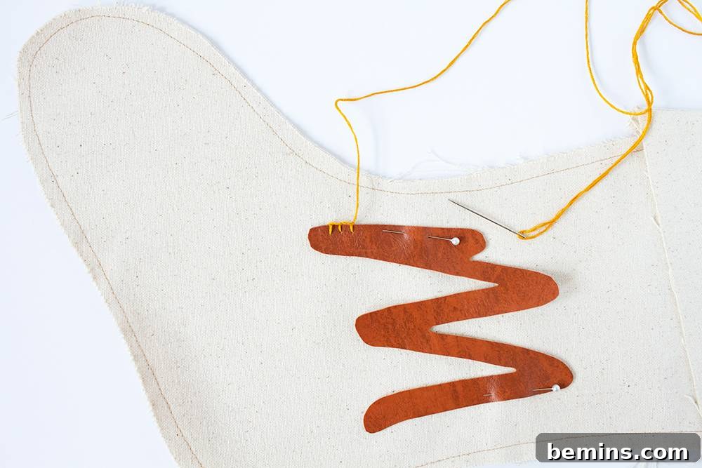 Fabric pattern being sewn onto a Christmas stocking.