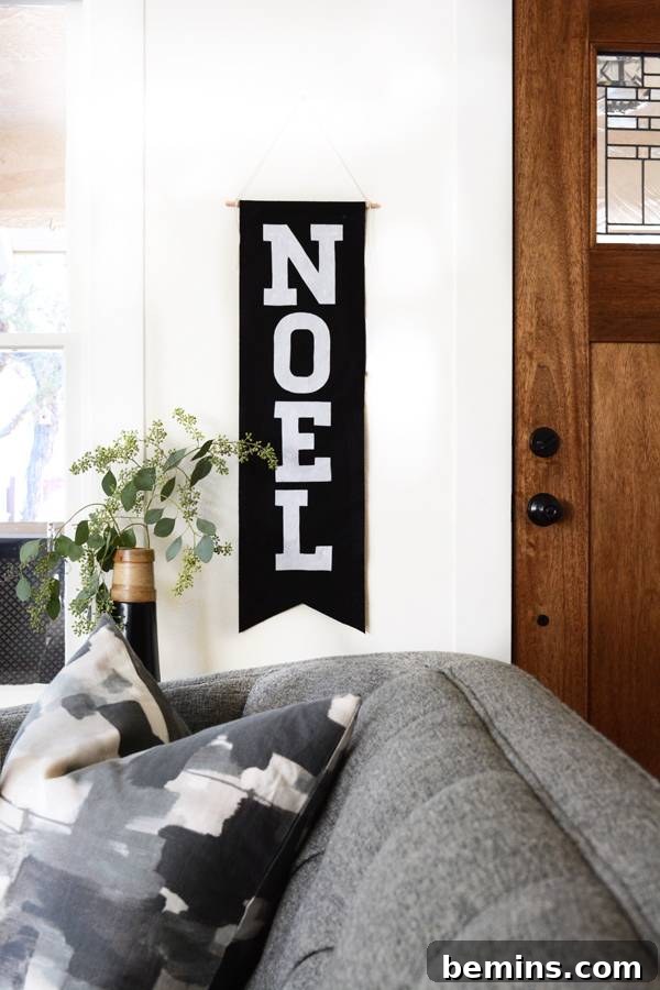 A cozy grey couch with a view of the door entrance
