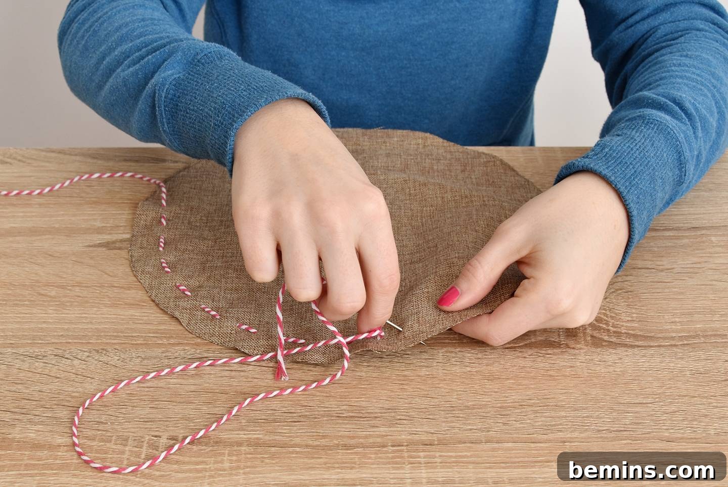 Sewing the edge of the cinch pouch with baker's twine