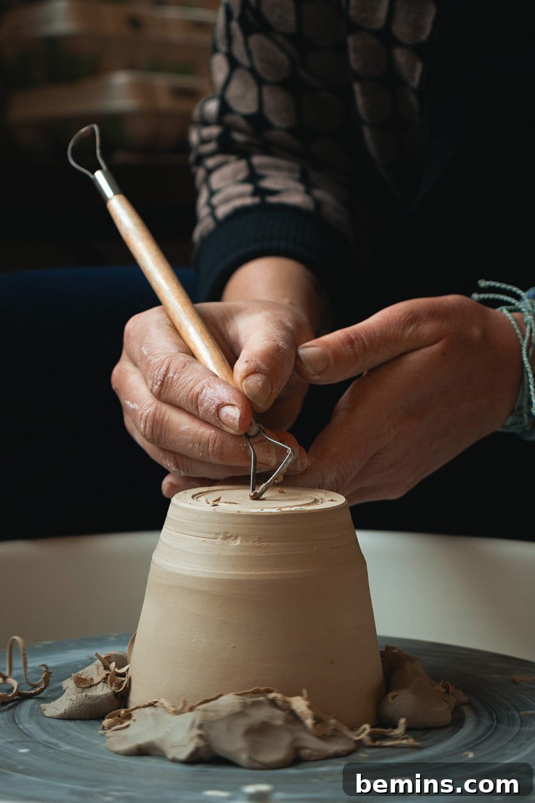 Person working at a potter's wheel, symbolizing learning a new craft