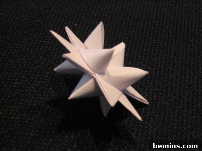 Paper star with multiple points on top of flat surface. These paper stars are perfect for adding a festive touch to any space.