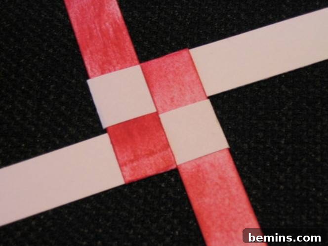 Two brown strips of paper and two red strips of paper in a basket weave. Folding the strips backwards is crucial for creating the star's points.
