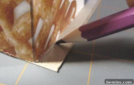 Image showing a pencil marking a line on the cardboard box to indicate where to fold or trim the excess flaps.