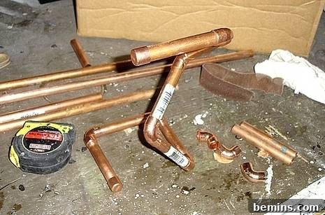 Crafting Copper Art Projects with New Soldering Skills 4 A more complex and artistic arrangement of copper pipes and fittings, showcasing an evolving design through creative handwork with soldering materials.