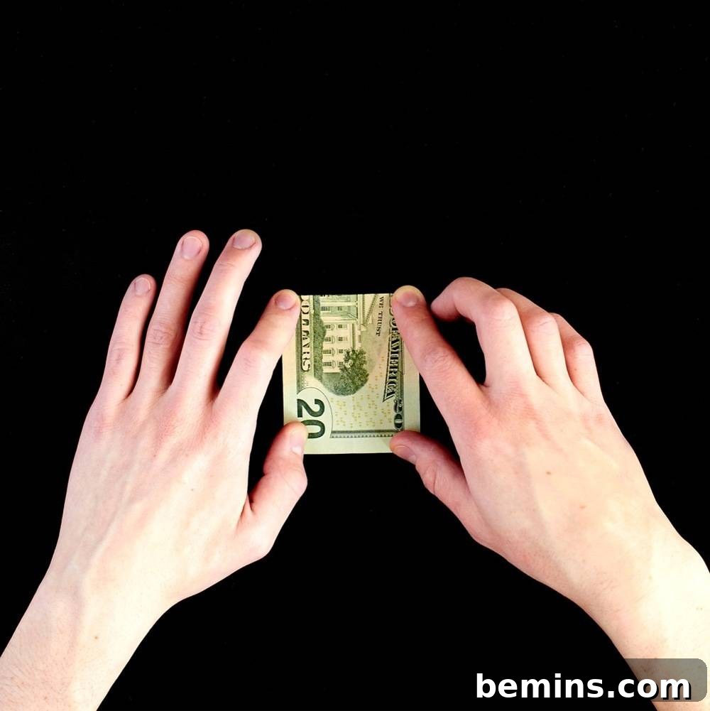 Folding the dollar bill in half the short way