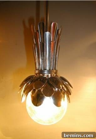 Hanging light fixture made from stainless steel spoons, showcasing a unique and artistic design.