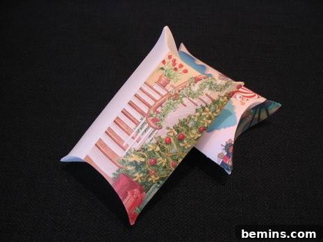 Two decorative pillows made from greeting cards, one lying on top of the other.