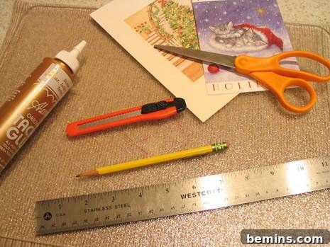 A collection of craft supplies including greeting cards, scissors, a ruler, glue, and a pencil.
