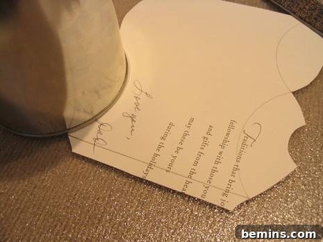 A glass being used to trace a curved line on the greeting card.
