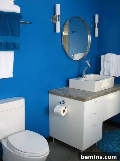 3-12-splat2.jpg. A close-up of the DIY bathroom featuring concrete countertops, stylish sconces, and the impressive tile mosaic shower wall.