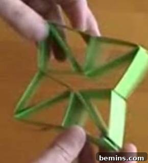 A person is explaining how to make a paper toy.
