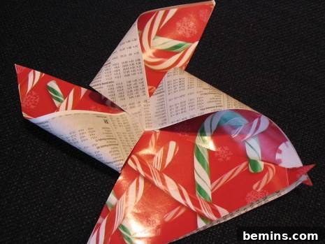 A DIY paper bow made of red and green candy cane wrapping paper.