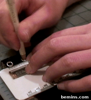 A person is marking something with the help of a ruler.