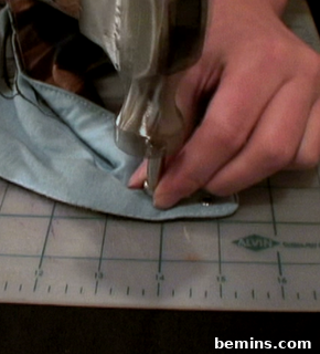 A person is using a material on a grid.