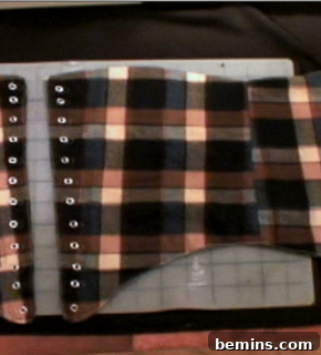 A plaid outfit with brown, pink and grey colors on a table.