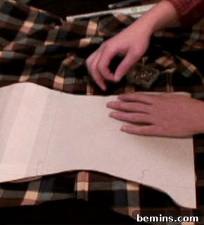 A woman sewing two pieces of fabric together.