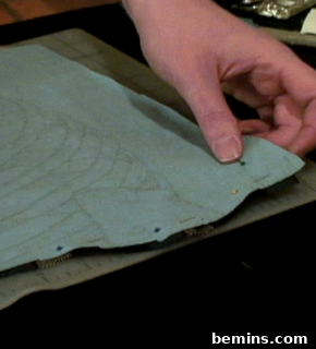 A person placing two pieces of fabric together.
