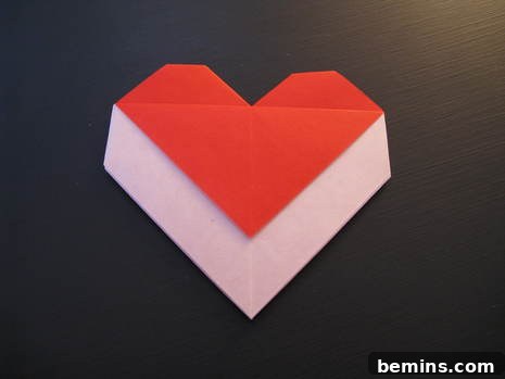 Handmade heart-shaped origami envelope using red and white paper