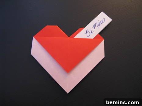 Origami heart envelope made using red and white paper