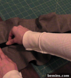 Sewing the elastic while stretching it.