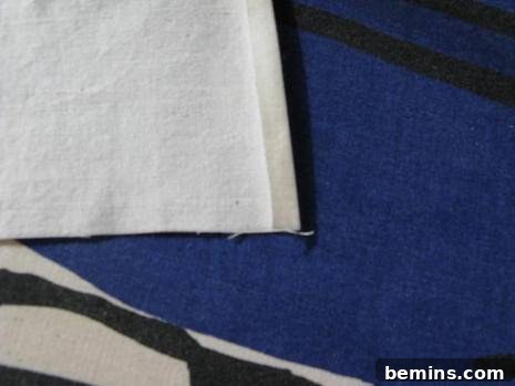 Folding and pressing the first sides of the fabric