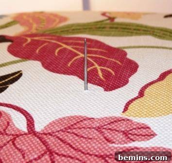 Marking the fabric for precise button placement.