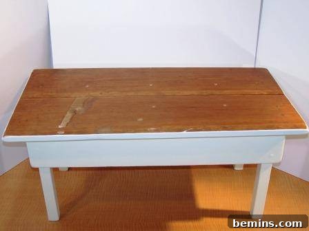 A wooden table painted white, ready for the next stage of the transformation.