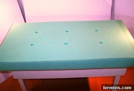 The foam cushion is securely attached to the top of the bench.