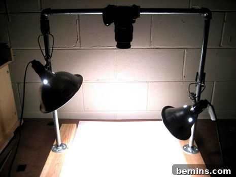 Black desk lights shine down on a desk. A DIY camera stand is in the foreground, demonstrating its use for overhead photography.