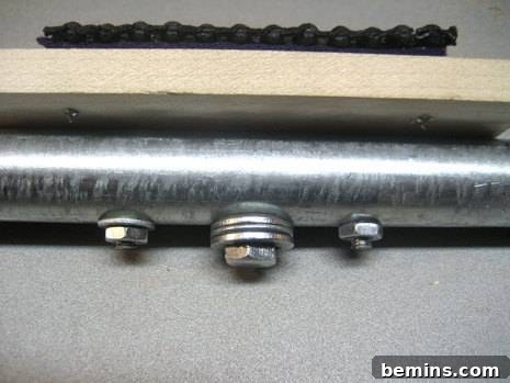 Fasteners are seen on a metal rod, illustrating the use of plumber's epoxy to secure the camera bolt to the mounting pipe.