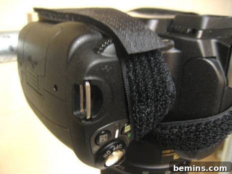 A black virtual reality headset with its protective cover on, secured by two Velcro strips around its body.