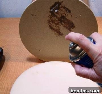 Applying spray adhesive to the bar stool base