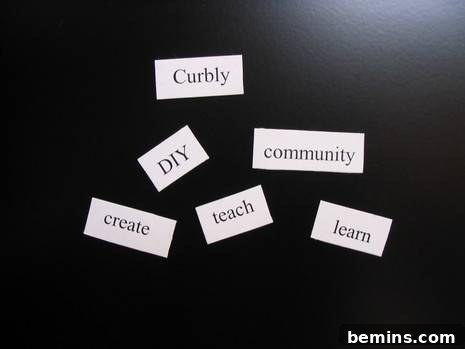 Close-up of individual word magnets neatly arranged on a black surface, displaying the finished DIY magnetic poetry set.