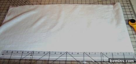 Fabric laid flat, ready for bias cutting with a rotary cutter and quilting ruler