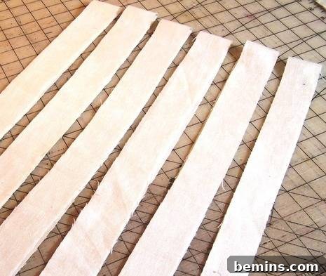 Collection of bias-cut fabric strips, ready to be joined for continuous length