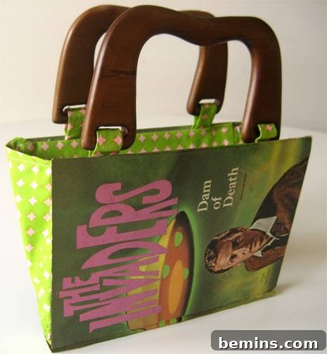 A unique handbag created from a vintage book with elegant wooden handles.